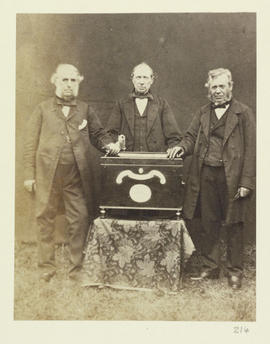 (Three men around a lectern/deeds box)