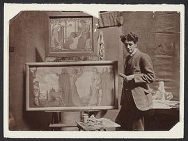 Photograph of William McCance in front of his work
