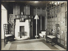 Interior with two chairs, fireplace and lampshade