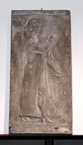 Plaster cast of figure of Ashurnasirpal II in relief holding a poppy (Version 1)