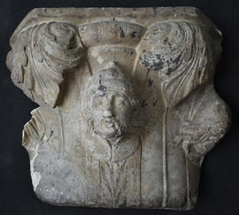 Plaster cast of capital with masks and foliage