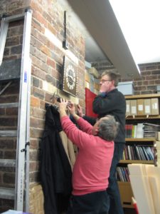 Horologist Nick Sanders and GSA Curator Peter Trowles work on one of the original Mackintosh clocks in the Archives and Collections Centre