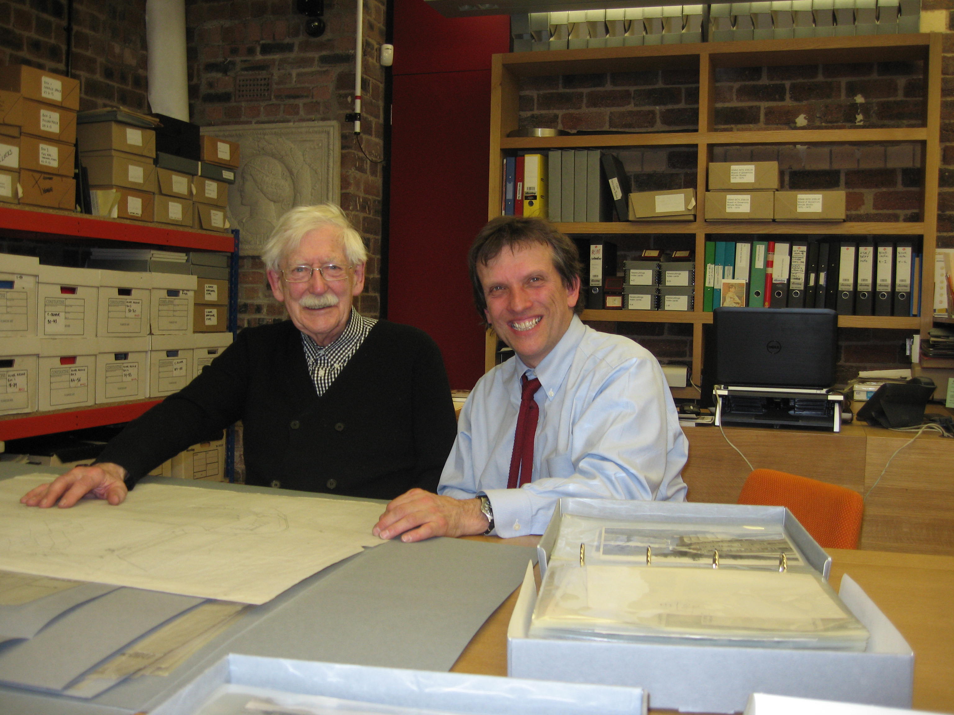 Andy MacMillan (left) and broadcaster Jonathan Glancey examining Gillespie, Kidd & Coia architectural drawings in our office