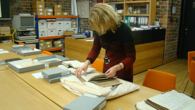 Alison Brown, curator of European Decorative Art at Glasgow Museums, examining items from our archives