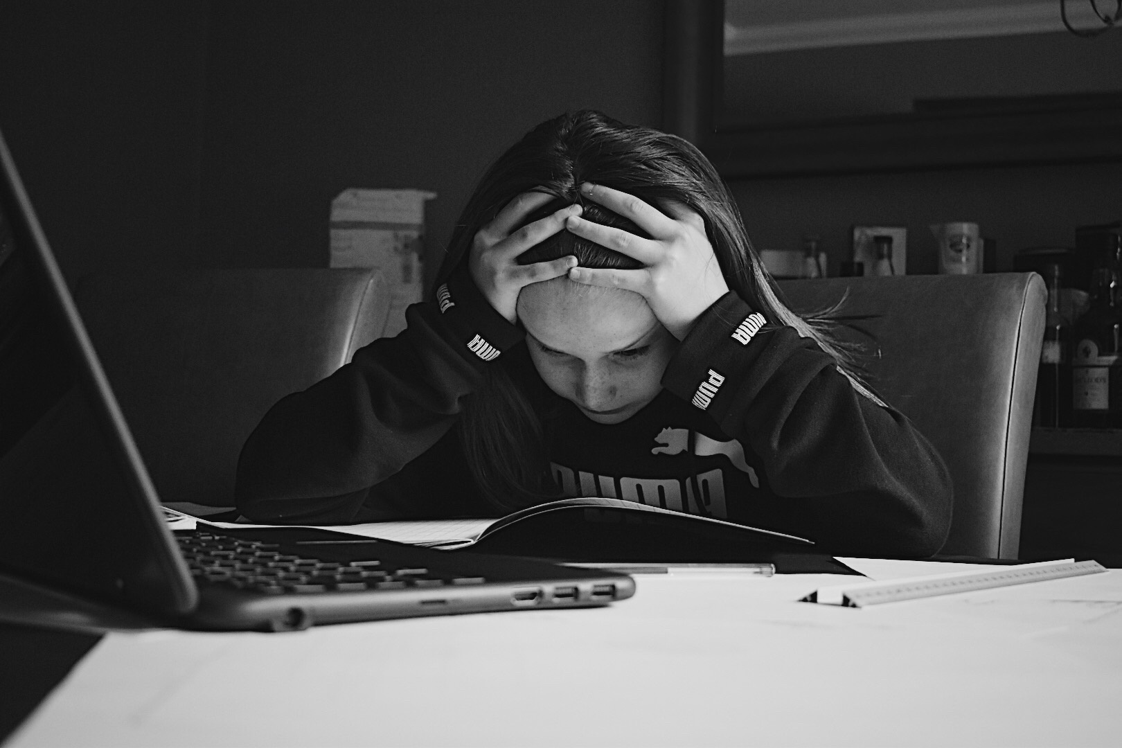 Black and white photograph of girl looking stressed