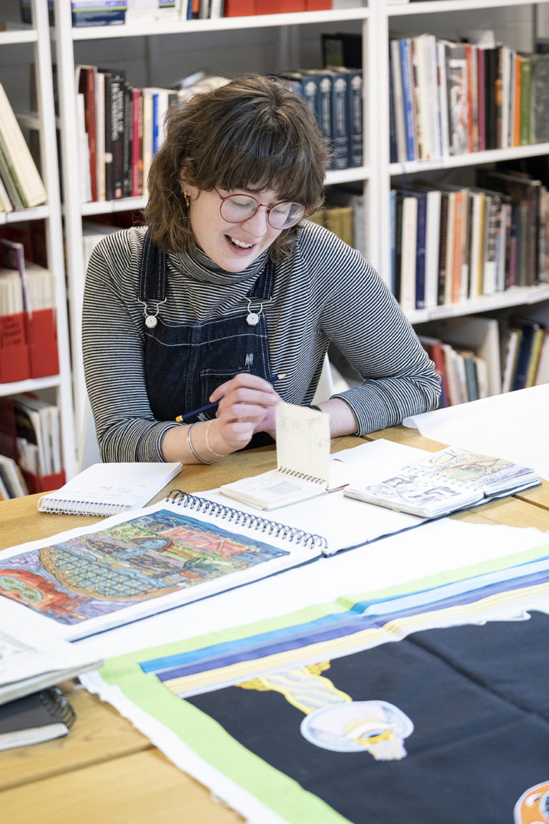 Image of person engaging with Archives and Collections documentation and artwork