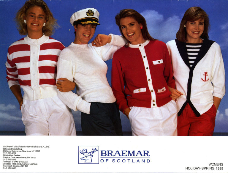 Glossy page from a brochure showing four women in red, white and blue knitted jumpers and cardigans. Text under the image reads “Braemar of Scotland” and depicts a stag’s head logo.